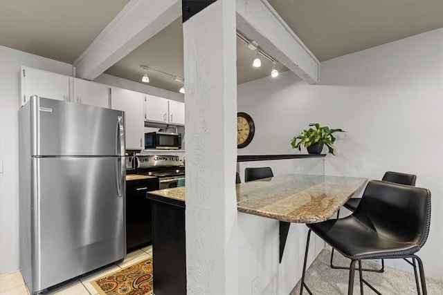 818 Broad St, Steamboat Springs, CO 80487 - kitchen featuring stainless steel appliances, track lighting, a breakfast bar, light countertops, and white cabinets