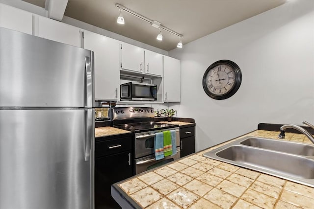 818 Broad St, Steamboat Springs, CO 80487 - kitchen featuring appliances with stainless steel finishes, a sink, and white cabinets