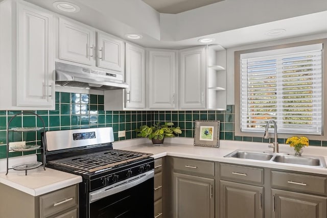 818 Broad St, Steamboat Springs, CO 80487 - kitchen with stainless steel range with gas cooktop, under cabinet range hood, a sink, light countertops, and white cabinets