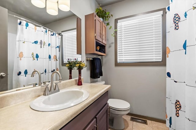818 Broad St, Steamboat Springs, CO 80487 - bathroom with vanity, toilet, tile patterned flooring, a shower with shower curtain, and baseboards