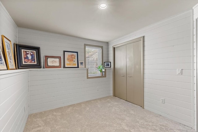 818 Broad St, Steamboat Springs, CO 80487 - unfurnished bedroom featuring carpet floors, a closet, and wooden walls