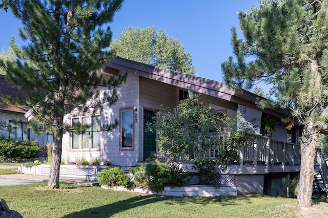 818 Broad St, Steamboat Springs, CO 80487 - view of side of home with a lawn and a deck