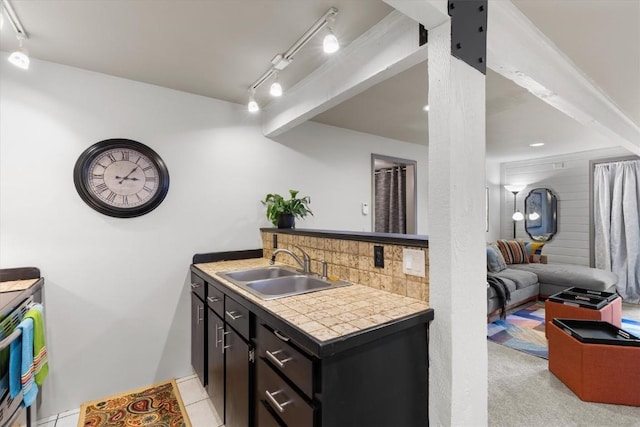 818 Broad St, Steamboat Springs, CO 80487 - kitchen with a sink, track lighting, decorative backsplash, tile countertops, and dark cabinetry