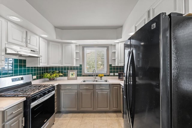 818 Broad St, Steamboat Springs, CO 80487 - kitchen featuring freestanding refrigerator, stainless steel gas range oven, a sink, under cabinet range hood, and gray cabinets