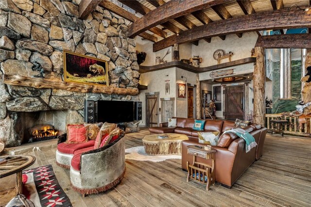 living area featuring wood ceiling, beam ceiling, a fireplace, and hardwood / wood-style flooring