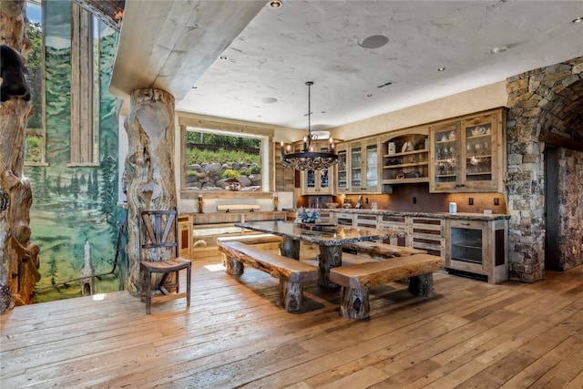 dining area featuring light wood-style floors and a chandelier