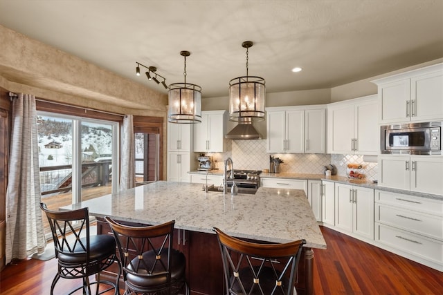 22755 Snowbird Trl, Oak Creek, CO 80467 - kitchen featuring stainless steel microwave, a sink, dark wood-type flooring, white cabinets, and recessed lighting