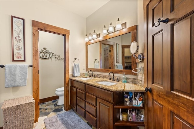 22755 Snowbird Trl, Oak Creek, CO 80467 - bathroom with double vanity, toilet, baseboards, and stone finish flooring