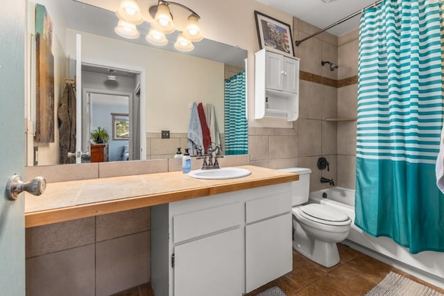 1340 Athens Plz Unit 16, Steamboat Springs, CO 80487 - full bathroom featuring shower / bath combo, vanity, tile patterned flooring, toilet, and tile walls