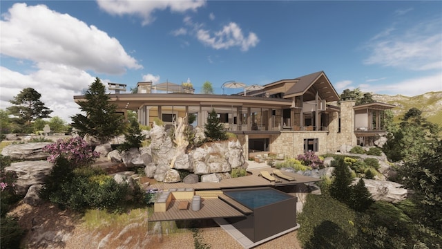 back of property with stone siding and a mountain view
