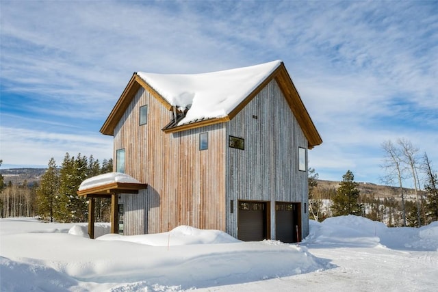 21185 County Road 16, Oak Creek, CO 80467 - view of snow covered exterior with an attached garage