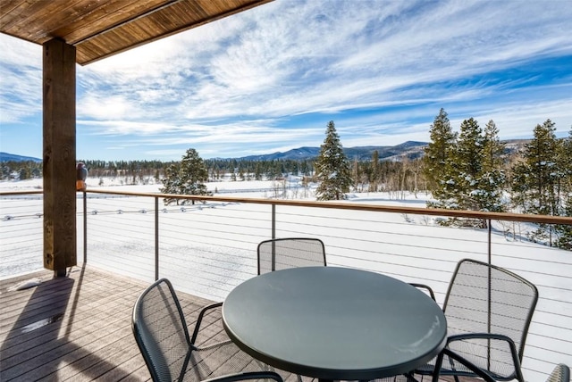 21185 County Road 16, Oak Creek, CO 80467 - snow covered deck featuring a mountain view and outdoor dining space