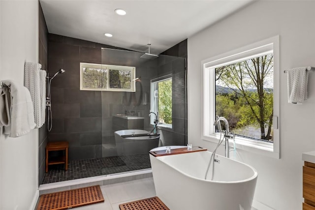 410 River Rd, Steamboat Springs, CO 80487 - full bathroom featuring a walk in shower, a freestanding bath, recessed lighting, vanity, and tile patterned floors
