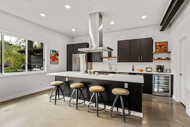 410 River Rd, Steamboat Springs, CO 80487 - kitchen featuring beverage cooler, ventilation hood, open shelves, appliances with stainless steel finishes, and a breakfast bar