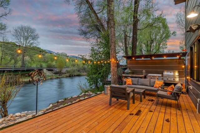 410 River Rd, Steamboat Springs, CO 80487 - deck featuring an outdoor living space, a water view, and area for grilling