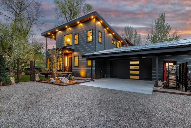 410 River Rd, Steamboat Springs, CO 80487 - modern home featuring an attached garage, driveway, a standing seam roof, and metal roof