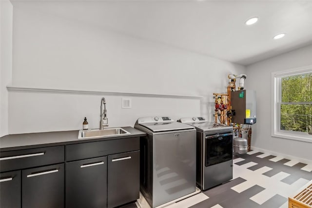 410 River Rd, Steamboat Springs, CO 80487 - laundry area featuring cabinet space, independent washer and dryer, tile patterned floors, tankless water heater, and recessed lighting