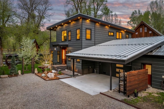 410 River Rd, Steamboat Springs, CO 80487 - back of house with a standing seam roof, metal roof, and driveway