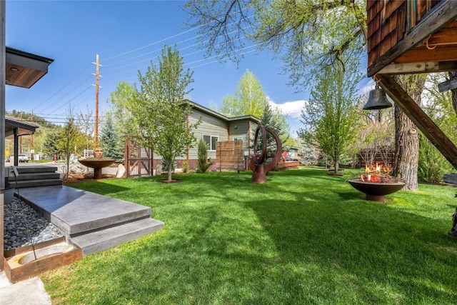 410 River Rd, Steamboat Springs, CO 80487 - view of green lawn with an outdoor fire pit
