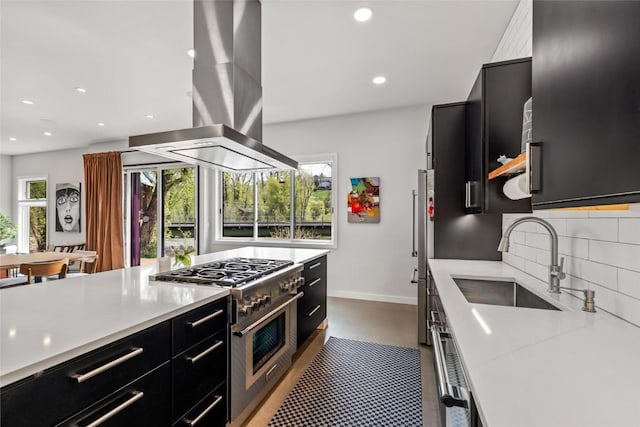 410 River Rd, Steamboat Springs, CO 80487 - kitchen featuring dark cabinetry, a sink, high end stainless steel range, island range hood, and recessed lighting