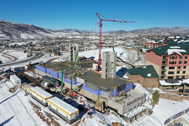 snowy aerial view featuring a mountain view