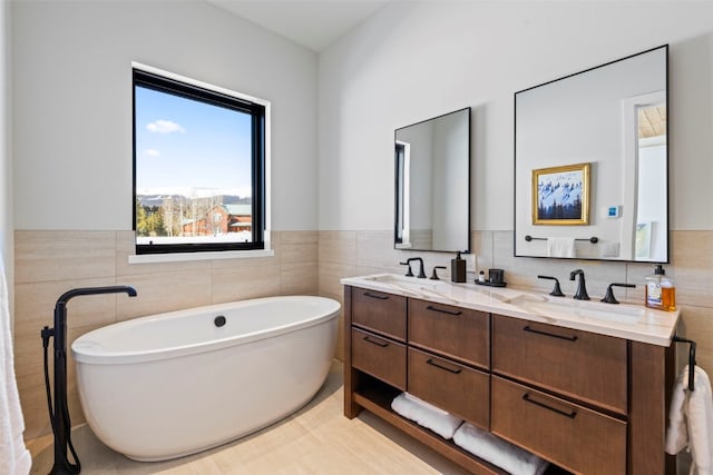 403 Revett Dr, Breckenridge, CO 80424 - full bath featuring tile walls, double vanity, a freestanding bath, and a wainscoted wall