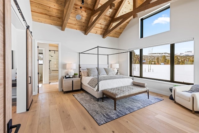 403 Revett Dr, Breckenridge, CO 80424 - bedroom featuring a wood ceiling with exposed beams, light wood-style flooring, high vaulted ceiling, and a barn door