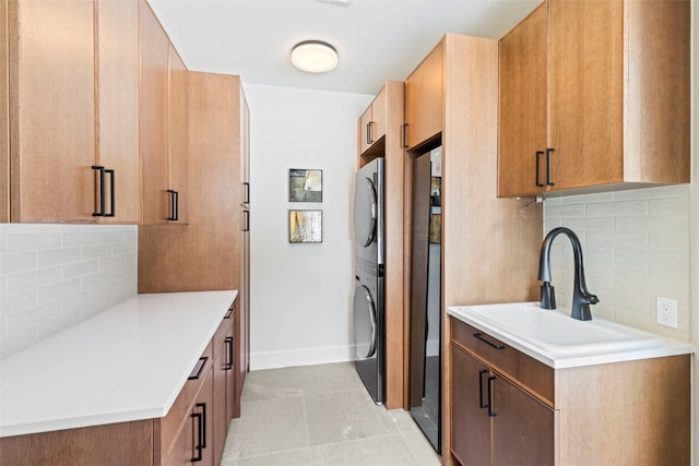 403 Revett Dr, Breckenridge, CO 80424 - kitchen featuring estacked washer and dryer, tasteful backsplash, light countertops, and light tile patterned floors