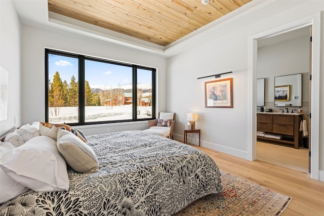 403 Revett Dr, Breckenridge, CO 80424 - bedroom with a tray ceiling, wood ceiling, light wood-style flooring, and connected bathroom