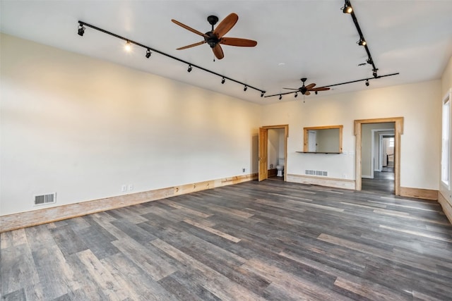 unfurnished living room with rail lighting, ceiling fan, visible vents, and wood finished floors