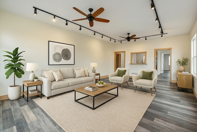 living area with dark wood-style floors, rail lighting, baseboards, and ceiling fan