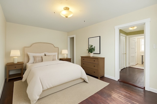 bedroom featuring baseboards and dark wood-style floors
