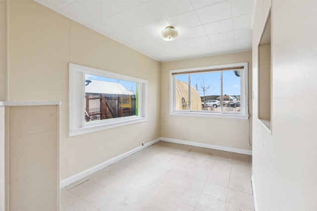 spare room featuring baseboards