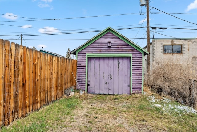 view of shed featuring fence