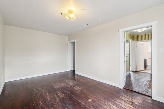 empty room with hardwood / wood-style flooring and baseboards