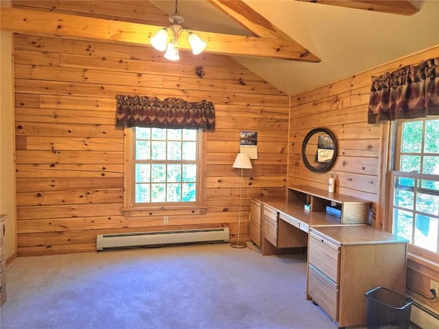 unfurnished office with built in desk, wooden walls, vaulted ceiling with beams, a baseboard radiator, and carpet flooring