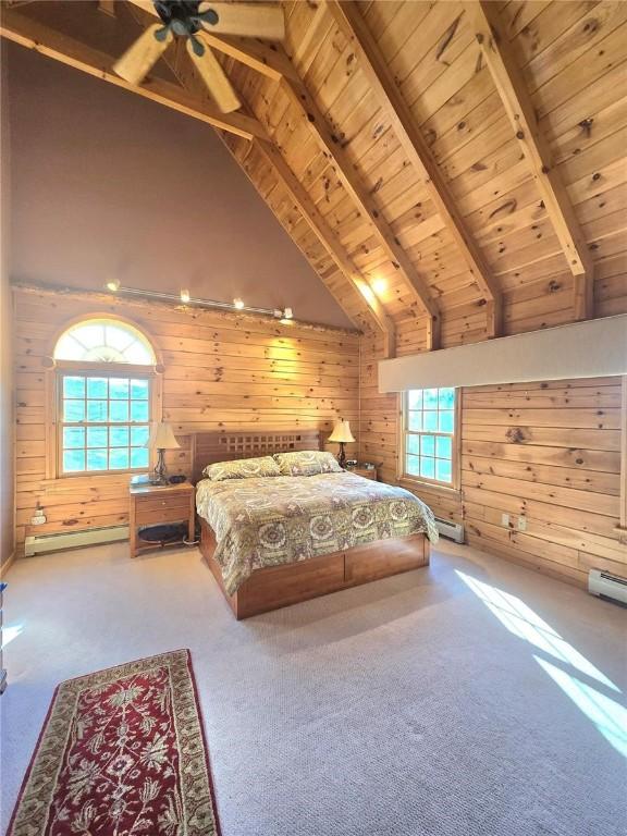 bedroom featuring a baseboard radiator, wood ceiling, carpet floors, wood walls, and beam ceiling