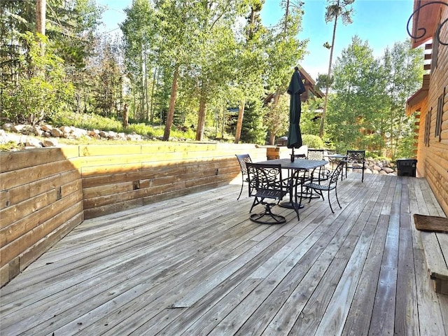 wooden deck featuring outdoor dining area