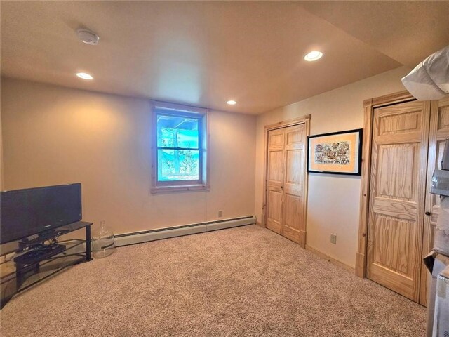 interior space featuring a baseboard radiator, recessed lighting, baseboards, and carpet