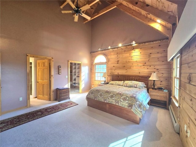 carpeted bedroom featuring wood walls, wooden ceiling, a baseboard heating unit, beamed ceiling, and high vaulted ceiling