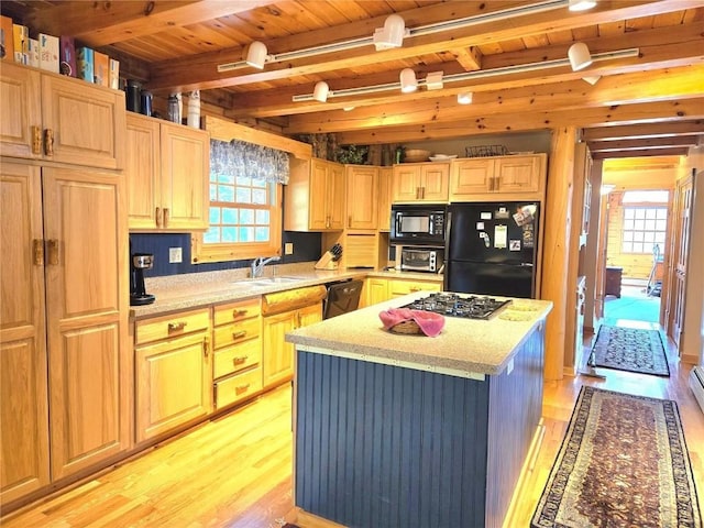 111 Shooting Star Way, Silverthorne, CO 80498 - kitchen featuring black appliances, a sink, light wood-style flooring, wooden ceiling with exposed beams, and healthy amount of natural light