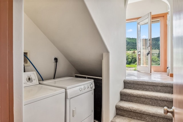 washroom with washing machine and dryer and laundry area