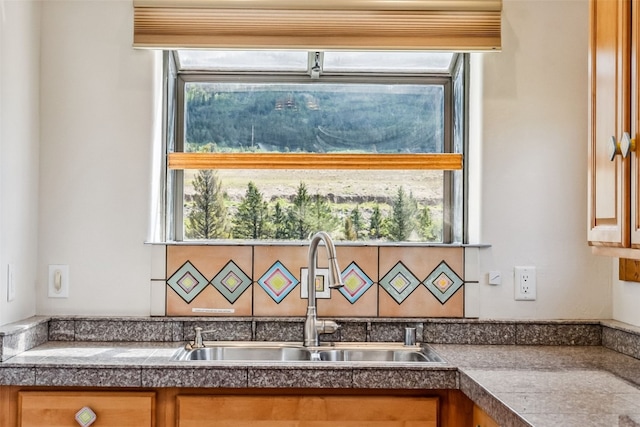 interior details featuring indoor wet bar, a sink, and tile countertops
