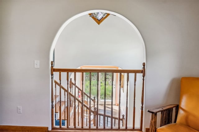 staircase featuring arched walkways