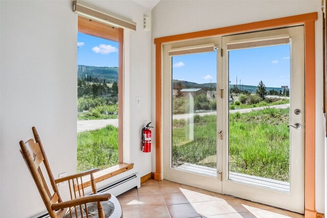 entryway with a healthy amount of sunlight and light tile patterned floors