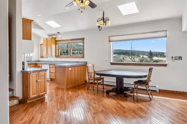 240 S Main St, Alma, CO 80420 - kitchen with a skylight, light wood finished floors, white dishwasher, a ceiling fan, and lofted ceiling