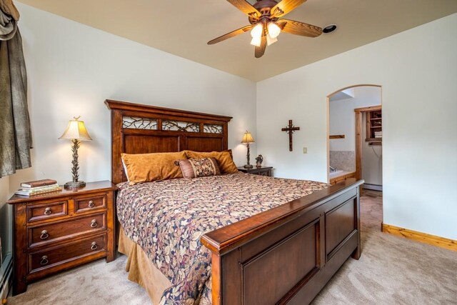2755 Waterstone Ln Unit 35, Steamboat Springs, CO 80487 - bedroom with light colored carpet, arched walkways, baseboards, and ceiling fan