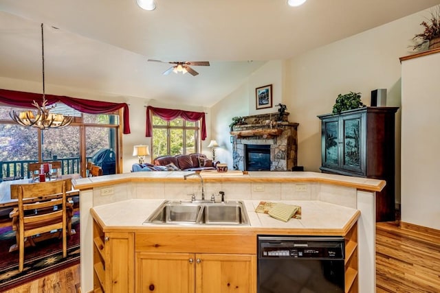 2755 Waterstone Ln Unit 35, Steamboat Springs, CO 80487 - kitchen with black dishwasher, tile counters, a sink, light wood-style flooring, and vaulted ceiling
