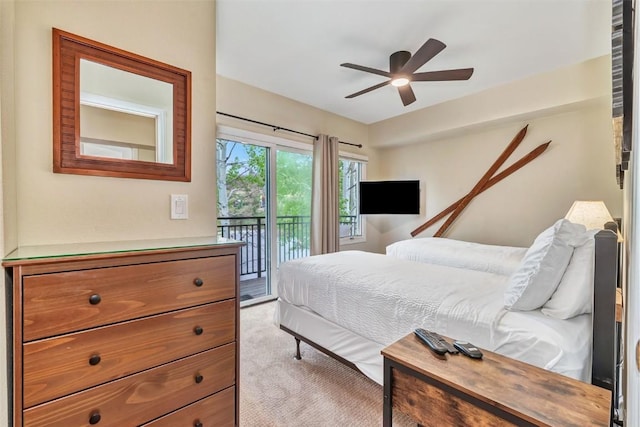 2883 Burgess Creek Rd Unit 302, Steamboat Springs, CO 80487 - bedroom featuring access to outside, light carpet, and a ceiling fan