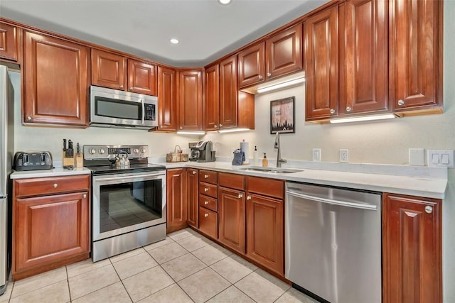 2883 Burgess Creek Rd Unit 302, Steamboat Springs, CO 80487 - kitchen featuring stainless steel appliances, a sink, light countertops, light tile patterned floors, and recessed lighting